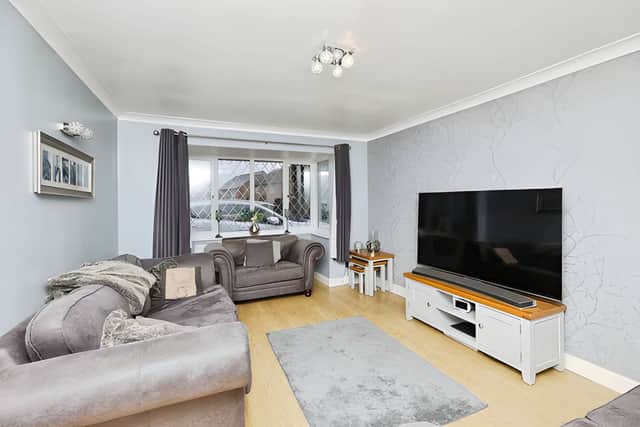 A bright bay window and living flame gas fire help make this a comfortable space to relax together.
