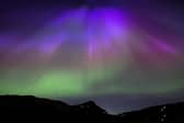 The aurora borealis, also known as the northern lights, above Arthur’s Seat and Salisbury Crags in Holyrood Park, Edinburgh in May. The lights are to be visible in Northern Ireland on the night of Monday 16 September 2024.