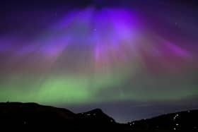 The aurora borealis, also known as the northern lights, above Arthur’s Seat and Salisbury Crags in Holyrood Park, Edinburgh in May. The lights are to be visible in Northern Ireland on the night of Monday 16 September 2024.