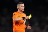 LEEDS, ENGLAND - AUGUST 18: Referee, Matt Donohue shows a yellow card during the Sky Bet Championship match between Leeds United and West Bromwich Albion at Elland Road on August 18, 2023 in Leeds, England. (Photo by George Wood/Getty Images) : There have been 51 red cards and 1,673 bookings in the Championship this season.