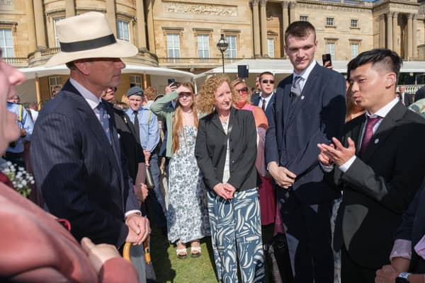 Adarsha, far right, signs to HRH The Duke of Edinburgh at DofE Gold Award celebration.