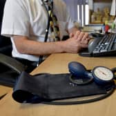 File photo dated 10/09/14 of a GP at their desk. GP appointments over the phone or online can miss serious illnesses and put patients at risk, according to a new study. Researchers said mistakes via remote consultation are rare, but there is a risk of patients being under-diagnosed, GPs being swayed by what has been said previously, and less qualified staff not acting on signs of illness. Issue date: Wednesday November 29, 2023.
