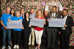 COSMO Derby staff with representatives from three local charities as they receive donation cheques.