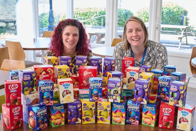 Claire Hollingshurst and Charlotte Hyman from Lubrizol with the pile of Easter eggs