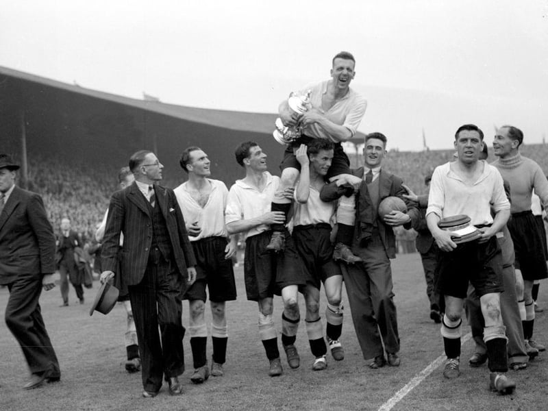 The Derby County team make a lap of honour around Wembley Stadium, carrying their captain Jack Nicholas and the FA Cup trophy, after their 4-1 victory over Charlton Athletic in the FA Cup final on 19th April 1946.
