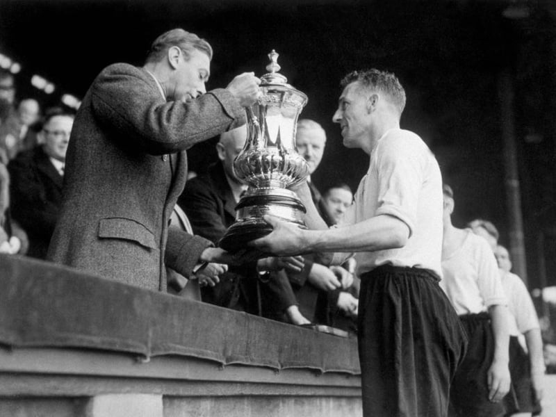 King George VI presents the FA Cup trophy to Jack Nicholas, the captain of Derby County, following the team's 4-1 victory over Charlton Athletic in the FA Cup final at Wembley Stadium on 27th April 1946.