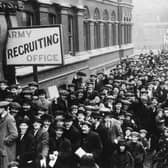 A crowd of young men queuing up at an Army Recruiting Office in December 1915,