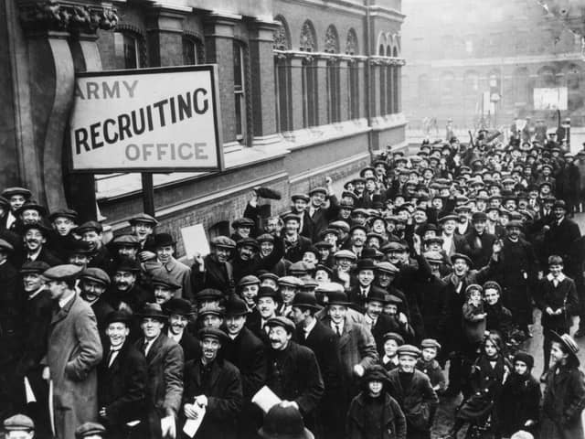 A crowd of young men queuing up at an Army Recruiting Office in December 1915,