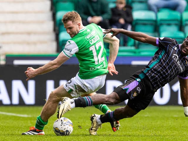 Hibs' Chris Cadden and St Johnstone's Adama Sidibeh tussle for possession at Easter Road.