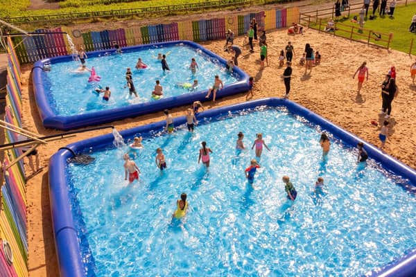 Children play in paddling pools at Farmarama with five gigantic pools this year. Photo: National Forest Adventure Farm