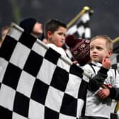 A young Derby supporters holds a flag prior to The Emirates FA Cup Fourth Round match between Derby County and Leicester City at iPro Stadium on January 27, 2017.