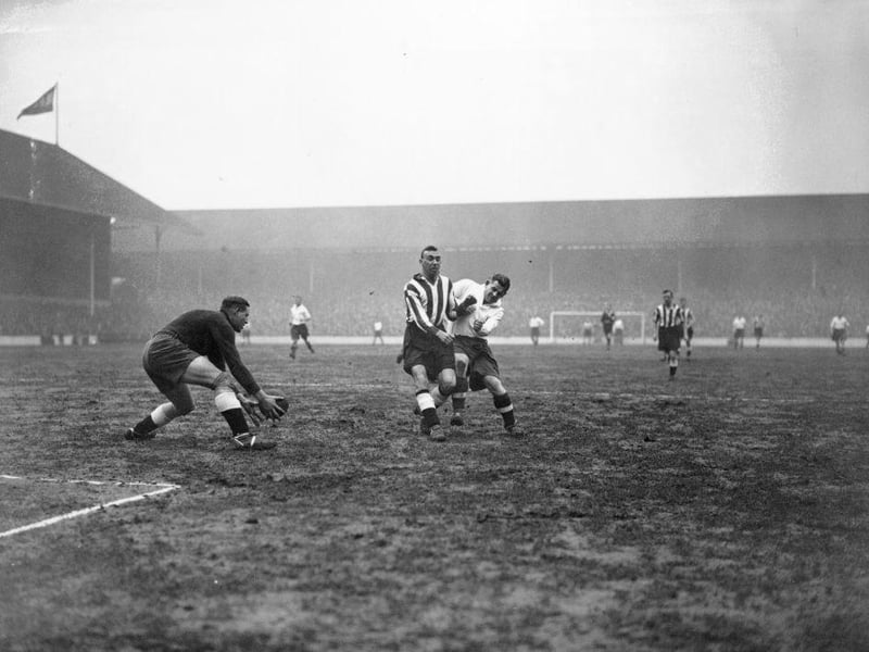 Derby defender Udall, keeps Spurs' Willie Evans at bay and allows Derby goalkeeper Kirby to collect the ball safely as Tottenham Hotspur play Derby County at White Hart Lane on 9th March 1935.