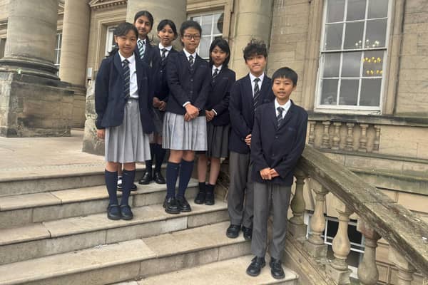 Children from Egypt, China and Dubai on the steps of Repton Prep School.