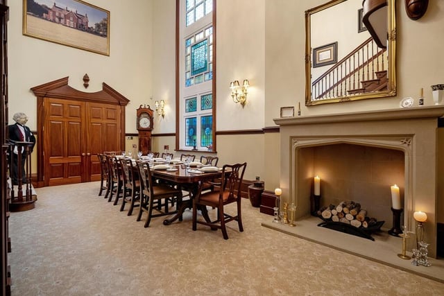 Another view of the large dining room shows an impressive stone built fireplace.