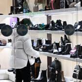 Stock image of a woman browsing in a shop.