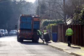 Council workers empty bins in Sunningdale, Berkshire .