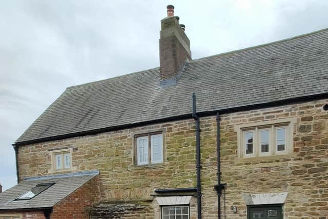 A DHBT volunteer surveying a Grade II listed building using the B@R app.