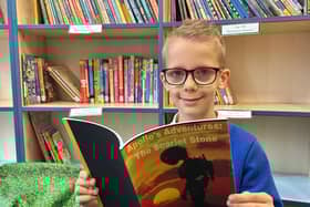 Logan Sparrow with the book he self-published