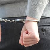 Stock picture of someone in handcuffs