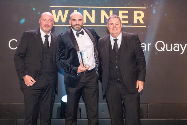Craig Vladimirovs, centre, on stage with awards night compere Mike Brewer, right, and Mark Barker, Development Manager at Warranty Solutions Group, who sponsored the Used Car Dealer Principal of the Year category this year