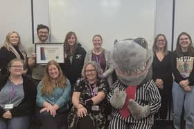 The team get their award from IMLT mascot Sid the Shark