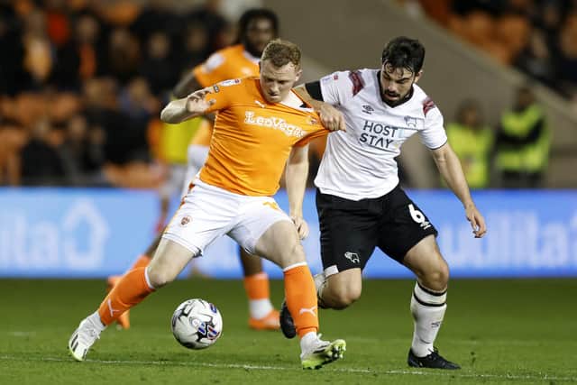 Blackpool's Shayne Lavery (left) and Derby County's Eiran Cashin battle for the ball during a Sky Bet League One match at Bloomfield Road, Blackpool. PIC: Richard Sellers/PA Wire