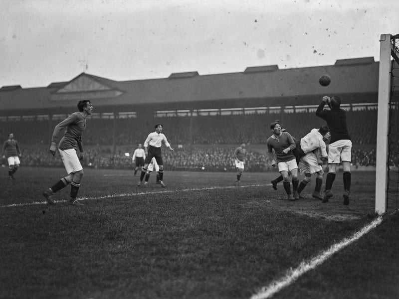 Chelsea goalkeeper Jim Molyneux punches away the ball during a match against Derby County at Stamford Bridge in November 15th 1913. Chelsea defeated Derby 2-1.